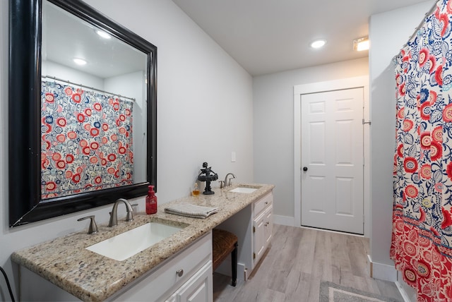 bathroom with vanity and hardwood / wood-style floors