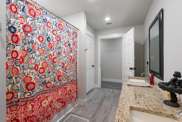 bathroom featuring vanity, wood-type flooring, and a shower with shower curtain