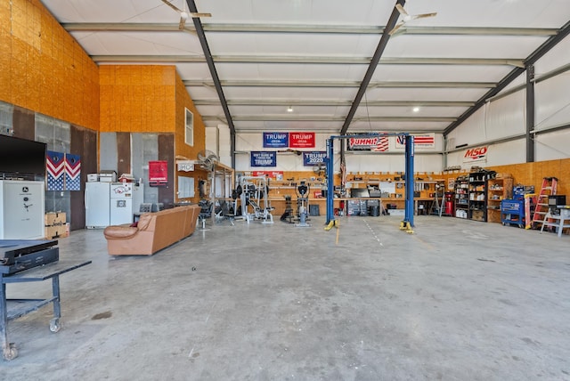 garage with a workshop area and white refrigerator