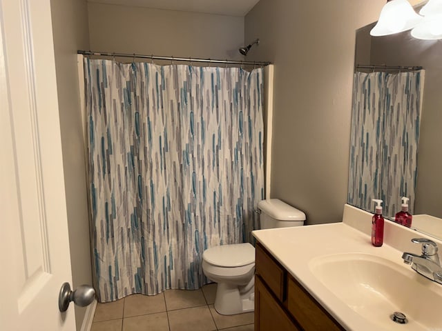 bathroom with vanity, a shower with shower curtain, toilet, and tile patterned floors