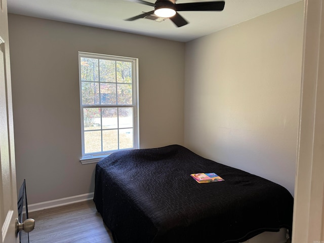 bedroom with ceiling fan and light wood-type flooring