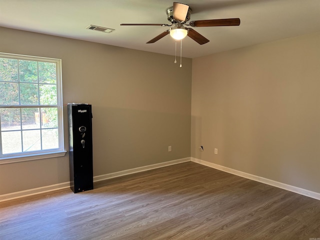 spare room with ceiling fan and dark hardwood / wood-style flooring