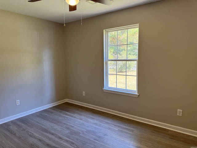 spare room featuring dark hardwood / wood-style floors and ceiling fan