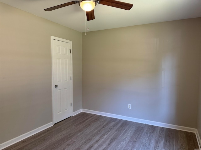 unfurnished room featuring dark hardwood / wood-style floors and ceiling fan