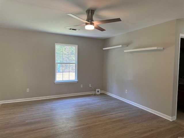 spare room with ceiling fan and dark hardwood / wood-style floors