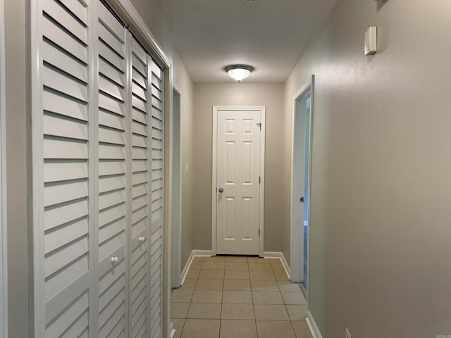 doorway with light tile patterned floors