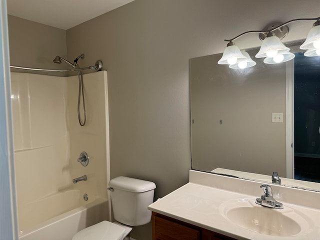 full bathroom featuring toilet, vanity, and  shower combination