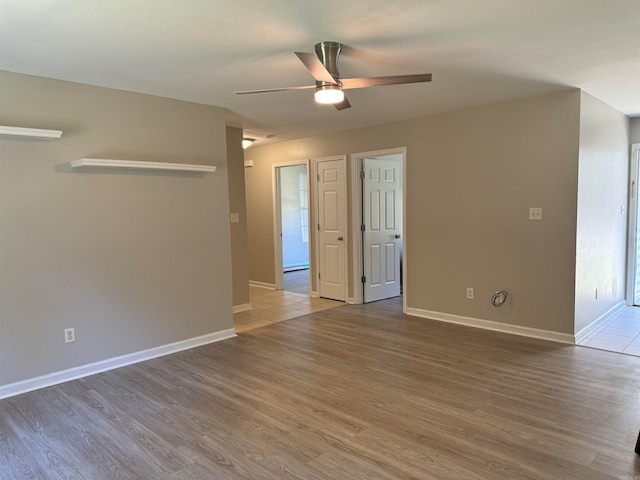 unfurnished room with hardwood / wood-style flooring and ceiling fan