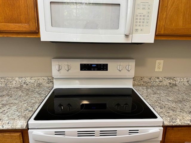 details featuring range and light stone countertops