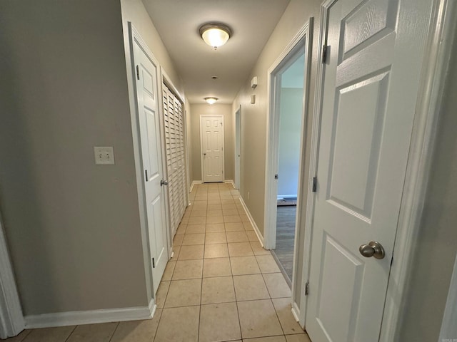 hall with light tile patterned floors