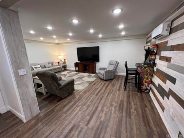 living room with an AC wall unit and dark hardwood / wood-style flooring