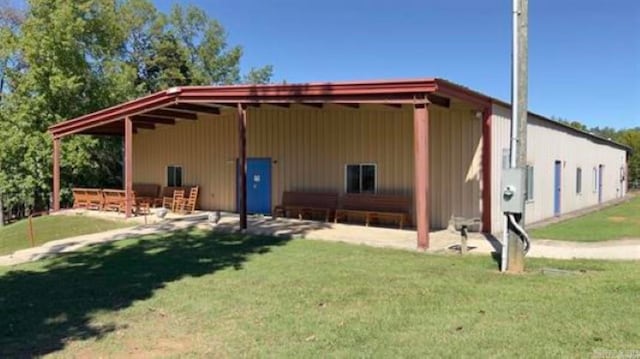 back of house featuring a patio and a yard