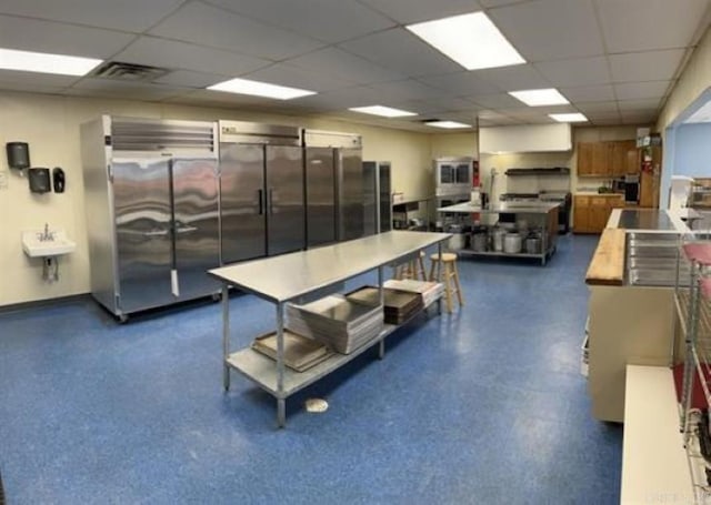 interior space featuring sink and a paneled ceiling