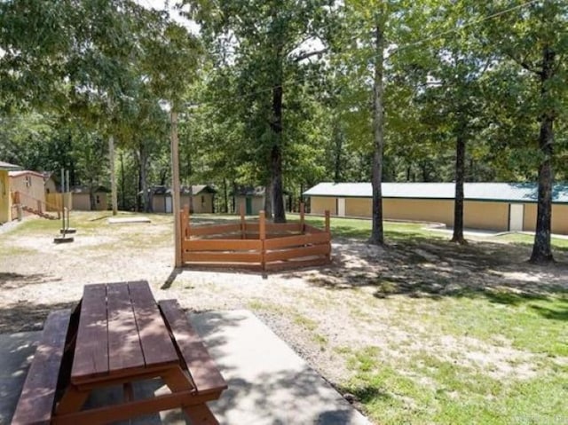 view of property's community with a wooden deck and a storage shed