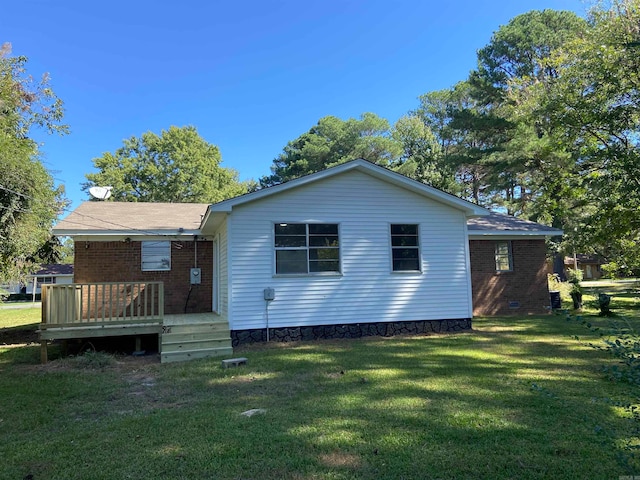 back of property featuring a yard