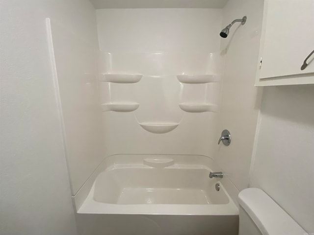 bathroom featuring toilet and bathing tub / shower combination