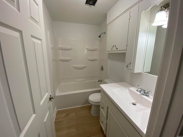 full bathroom with toilet, hardwood / wood-style floors, shower / tub combination, and vanity