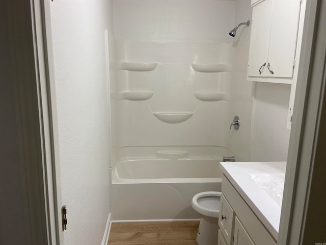 full bathroom with toilet, bathtub / shower combination, hardwood / wood-style floors, and vanity