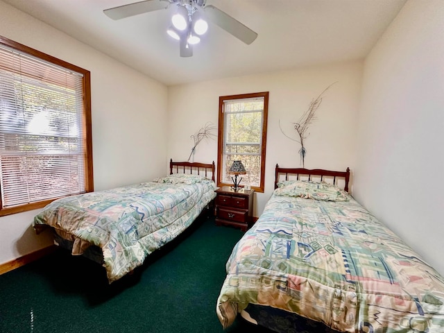 bedroom featuring dark colored carpet and ceiling fan