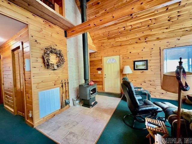 office space with a wood stove and wooden walls