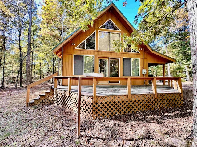 rear view of property featuring a wooden deck