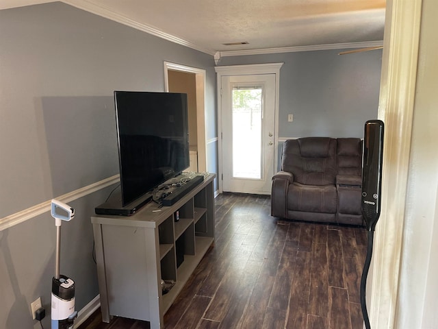 living room featuring ornamental molding and dark wood-type flooring