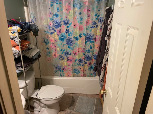 bathroom with toilet, shower / tub combo with curtain, and tile patterned floors