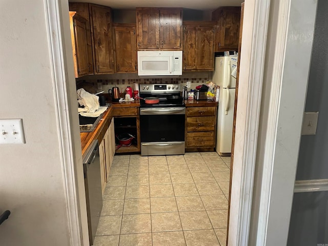 kitchen featuring backsplash, appliances with stainless steel finishes, and light tile patterned floors