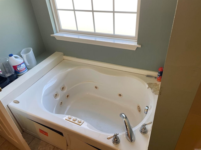 bathroom featuring tile patterned floors, a bath, and a wealth of natural light