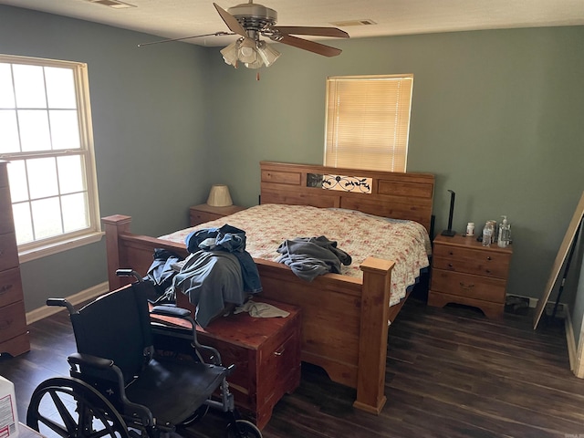 bedroom with dark hardwood / wood-style floors and ceiling fan