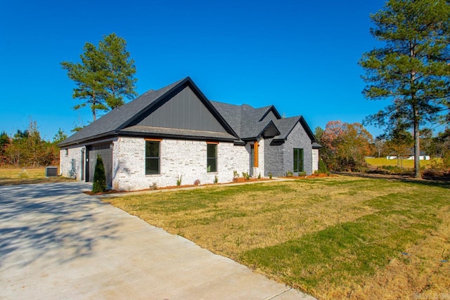 view of front of property with central AC and a front lawn