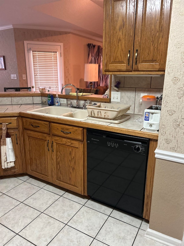 kitchen with black dishwasher, light tile patterned floors, crown molding, tile counters, and sink