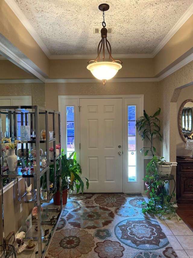 tiled foyer entrance with ornamental molding