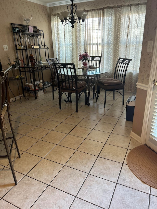 dining area featuring ornamental molding, an inviting chandelier, and tile patterned flooring