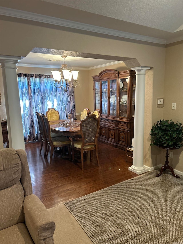 dining area featuring crown molding, a textured ceiling, a chandelier, and dark hardwood / wood-style floors