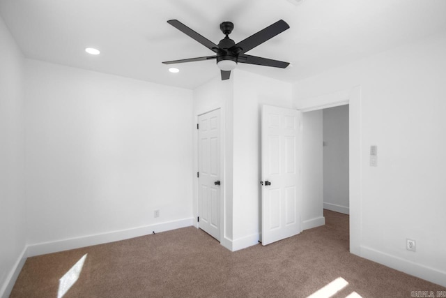 unfurnished bedroom featuring light colored carpet and ceiling fan