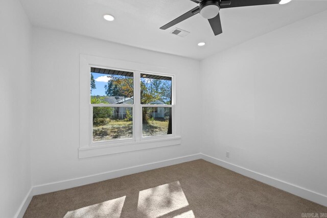 spare room featuring ceiling fan and carpet flooring