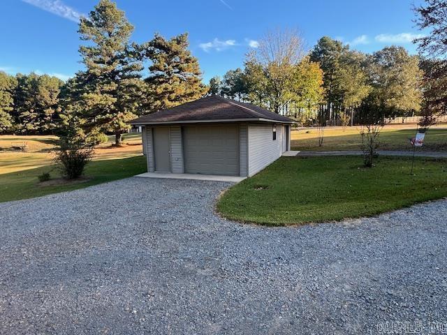 detached garage with gravel driveway