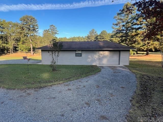 view of property exterior featuring a garage and a lawn