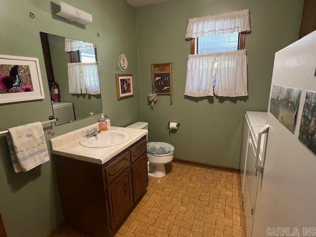 bathroom featuring toilet, a wall mounted air conditioner, and vanity