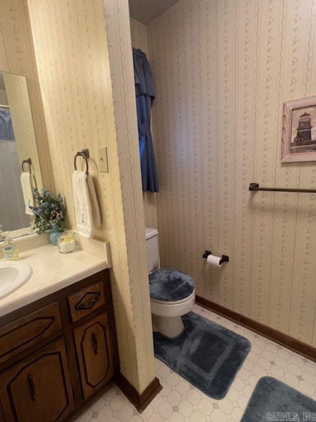 bathroom featuring toilet and vanity