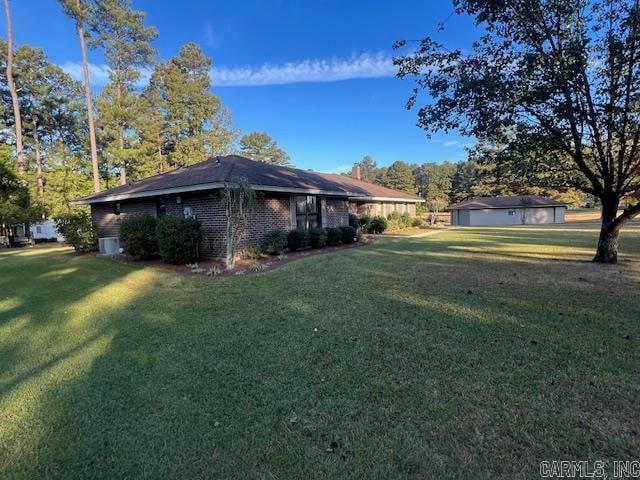 view of side of home with a yard