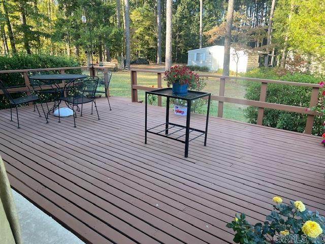 wooden terrace with outdoor dining area