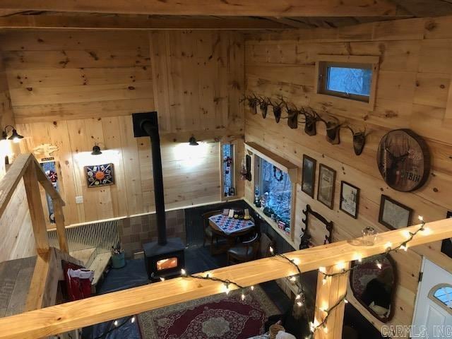 interior space featuring wood walls and a wood stove