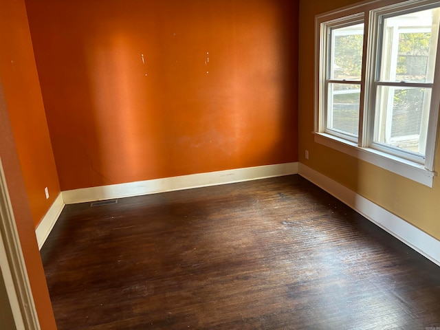 unfurnished room featuring dark hardwood / wood-style floors