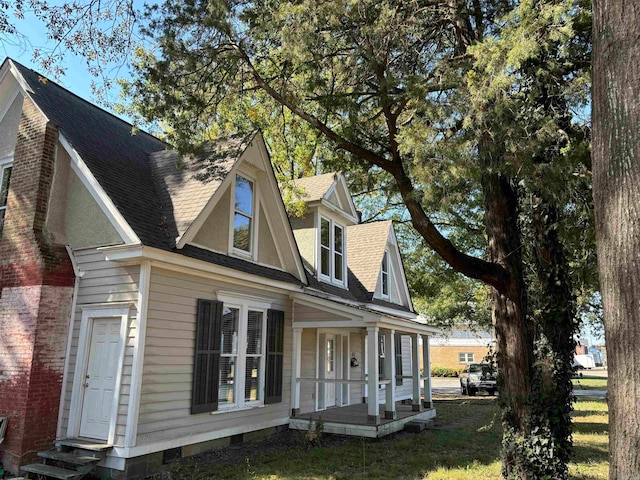 view of side of property featuring a yard and a porch