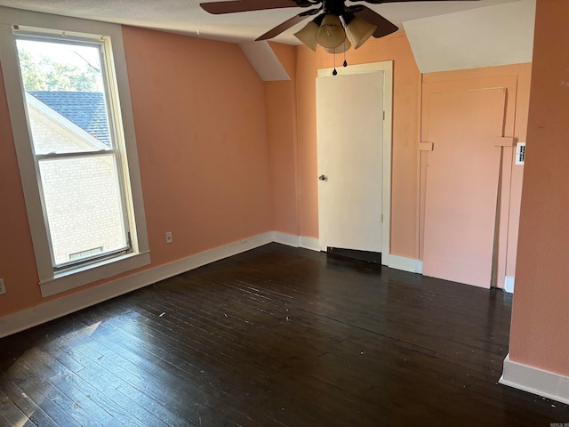 unfurnished room featuring vaulted ceiling, ceiling fan, and dark hardwood / wood-style flooring