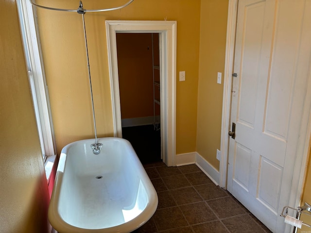 bathroom featuring tile patterned flooring and a washtub