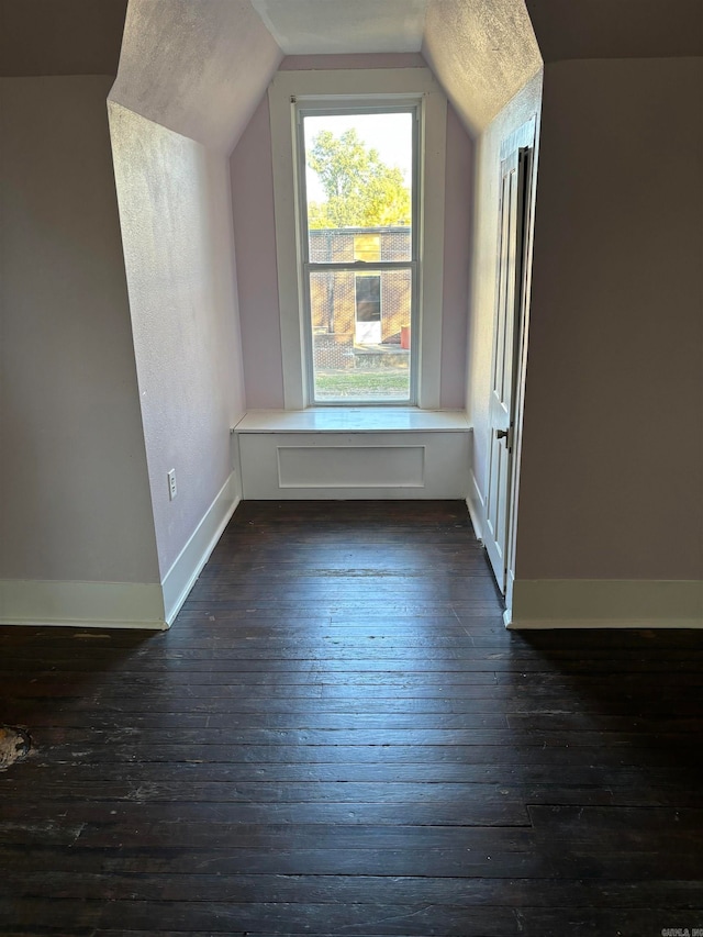 bonus room with vaulted ceiling and dark hardwood / wood-style flooring