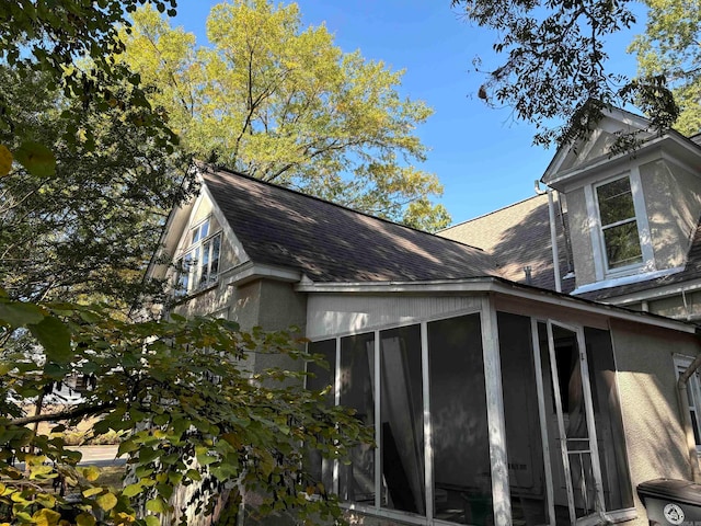 view of home's exterior with a sunroom